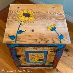 A boho vintage nightstand painted in distressed red & blue with honeycomb, sunflowers & bees.