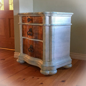 A farmhouse style, storage table in white & stained wood, painted & distressed for a weathered look with a smooth finish.