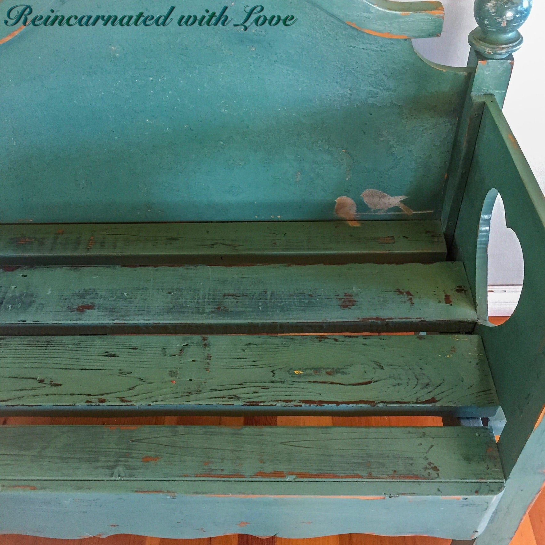 Close up of the front of bench shows the small bird accents in the bottom corner of the backrest.