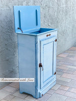 Shabby chic hamper with it’s lift top open.