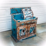 A rustic, farmhouse style, coffee bar, painted & heavily distressed in blue, with white & copper undertones, over solid wood.