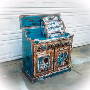 A rustic, farmhouse style, coffee bar, painted & heavily distressed in blue, with white & copper undertones, over solid wood.