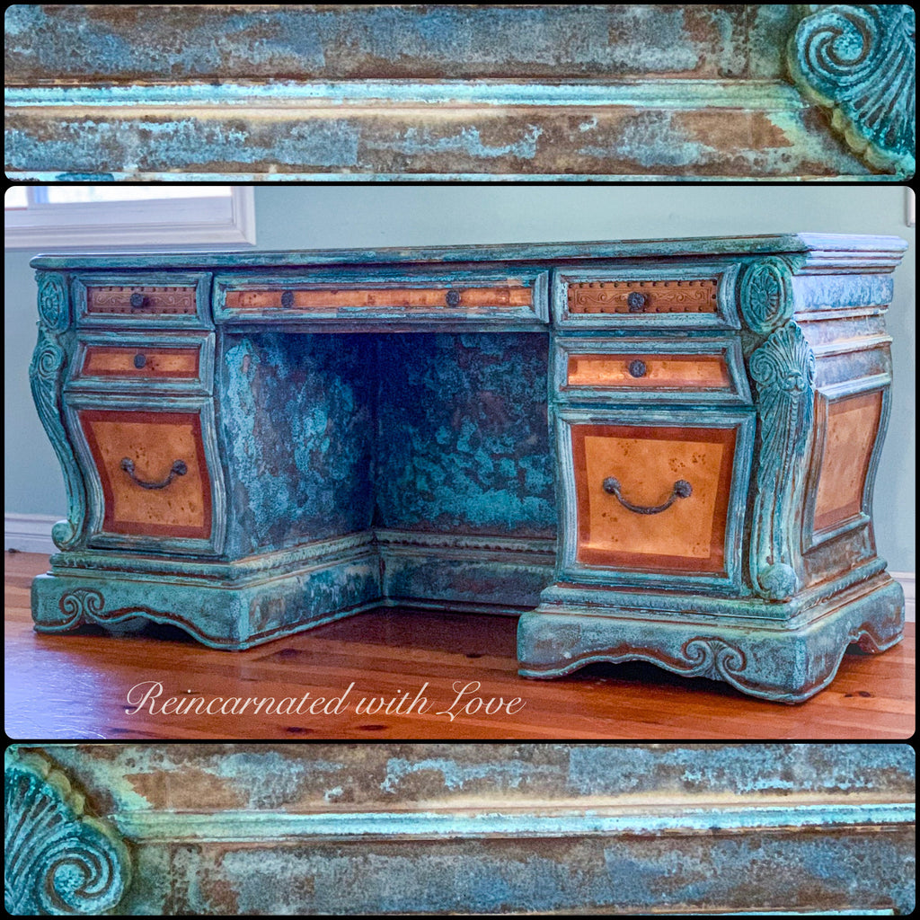 An art nouveau style desk, done in a boho finish, with blue & green hues, over stained wood.