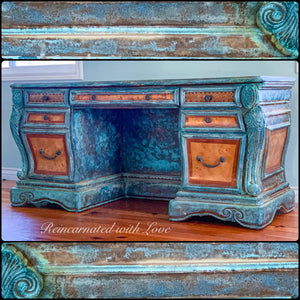 An art nouveau style desk, done in a boho finish, with blue & green hues, over stained wood.