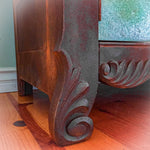 Close up of the art nouveau, wood carved detailing on a boho style dresser.