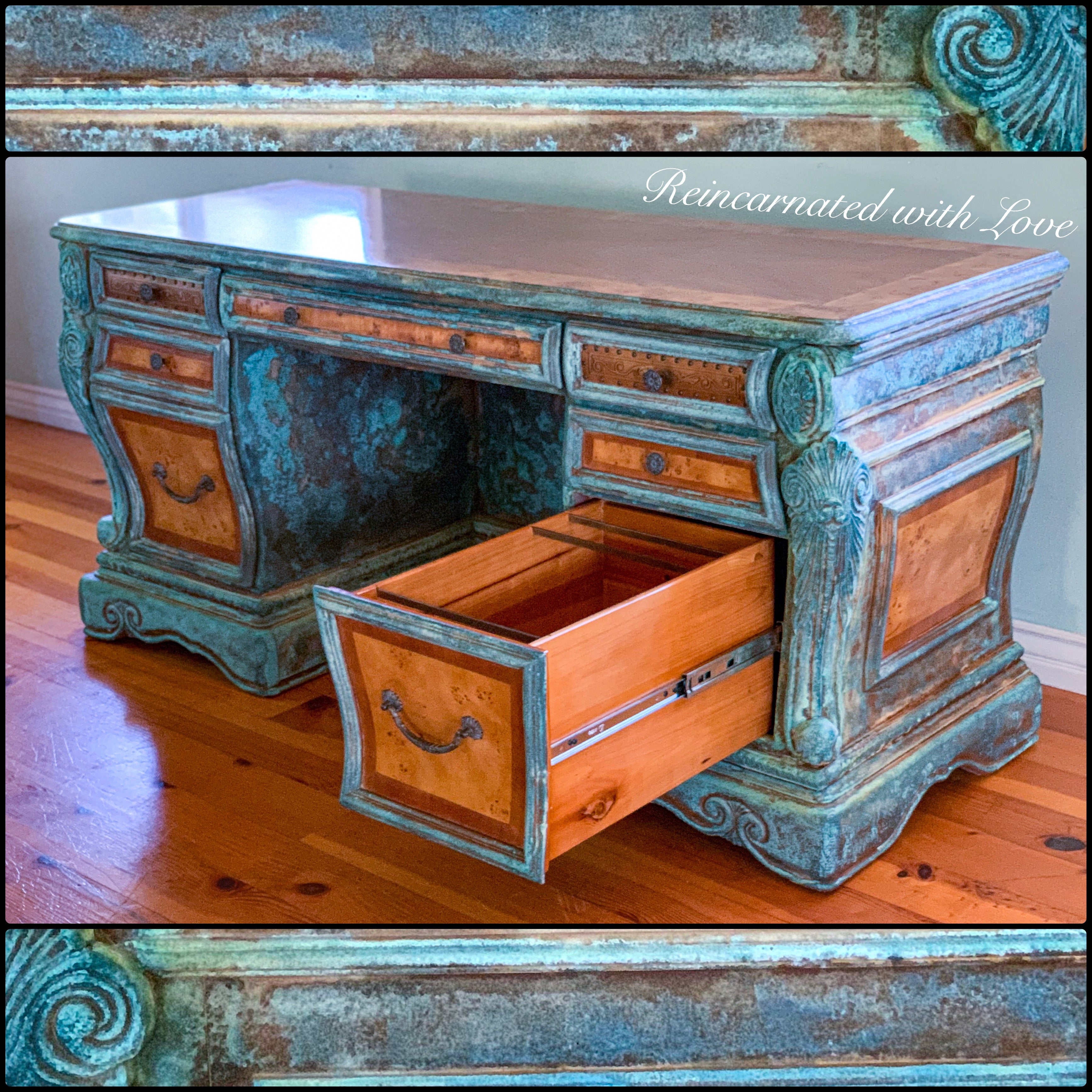 An art nouveau style desk, with a blue & green, patina finish, shown with a large drawer open, displaying storage capacity.