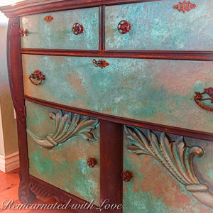 Art nouveau style, wood carved detailing on a dresser done in a rusted iron & copper, patina finish.