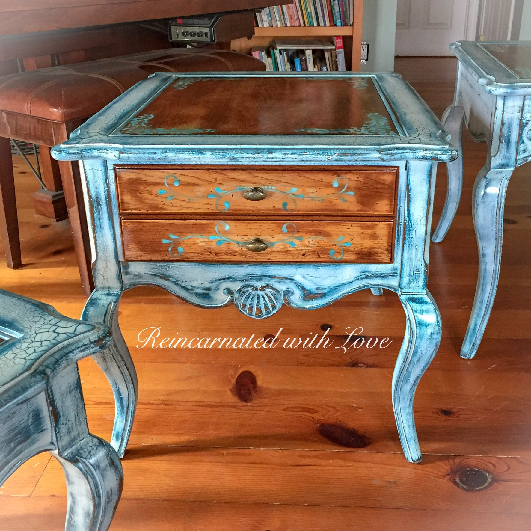 A French country style, end table with a stained wood tabletop, distressed, white trim, blue hues & damask accents.
