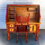A red, roll top desk & matching chair, painted in distressed red over stained, solid pine. 