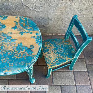 Shabby chic style kid’s table & matching chair, painted in stained wood with blue lace accents.