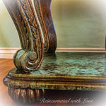Close up view of the rusted copper, green patina finish & wood carved detailing on an art-nouveau style, vintage, end table.
