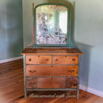 A farmhouse style, dressing table with a large mirror, painted with green, patina trim & stained wood.