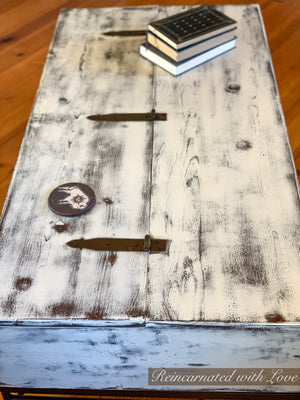 Birds eye view of the distressed white finish on a lift top, coffee table.