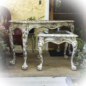 A sofa table & matching, end table, both painted in distressed white, with glass panels in the tabletops & curved legs.