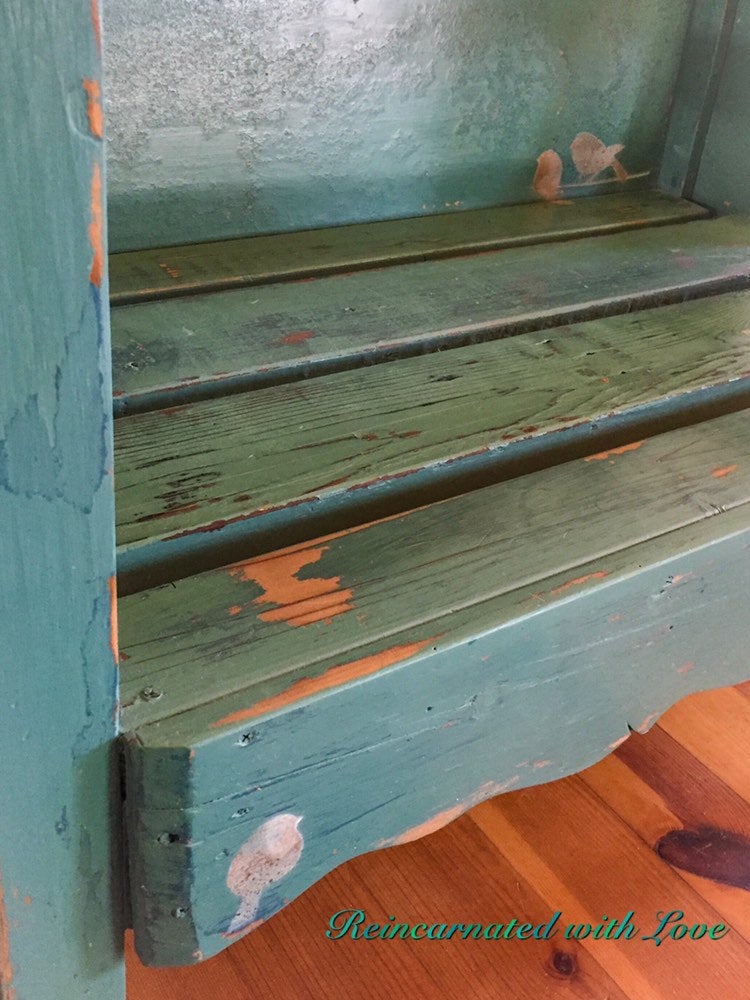 Close up of the benchseat, shows detail & texture in the shabby chic style, blue & green finish.