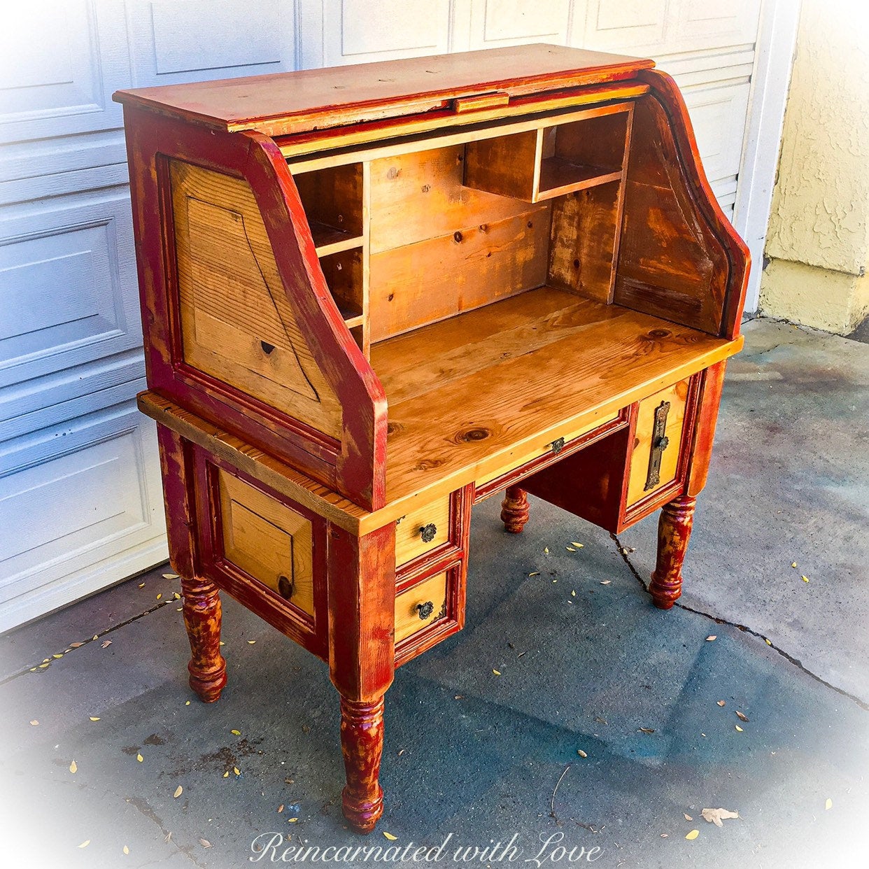 A red, roll top desk, painted with shabby chic, red trim, over stained, solid pine.