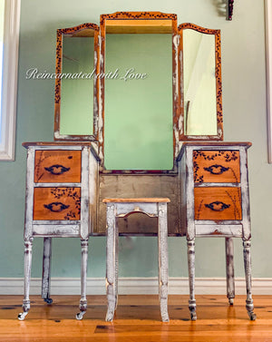 Distressed white & stained wood farmhouse style vanity table with an attached mirror and matching stool.