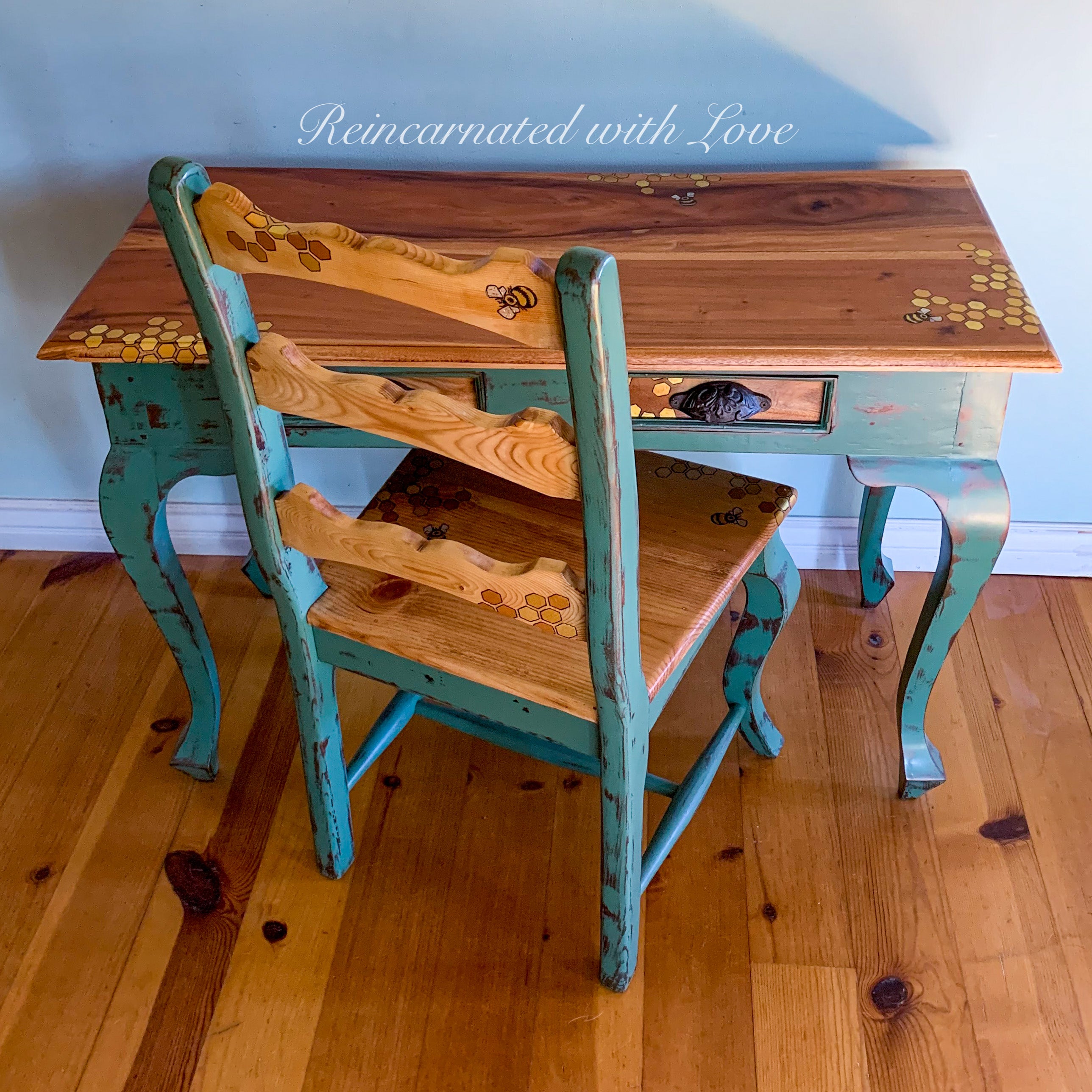 A vintage writing desk & chair set with honeycomb & tiny bee accents burnt into the stained wood portions.