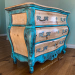 Side view of a boho dresser done in a patina rusted, blue & green finish over stained wood.