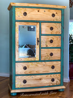 A tall vintage armoire with honeycomb & bee accents burnt into the wood grain of the drawer faces.