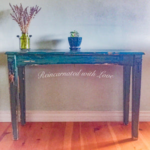 A shabby chic style, entryway table, with heart-shaped, key hooks, painted in distressed blue & green hues over solid wood.