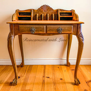 vintage writing desk with single drawer, ornate curved legs & desktop cubbies.
