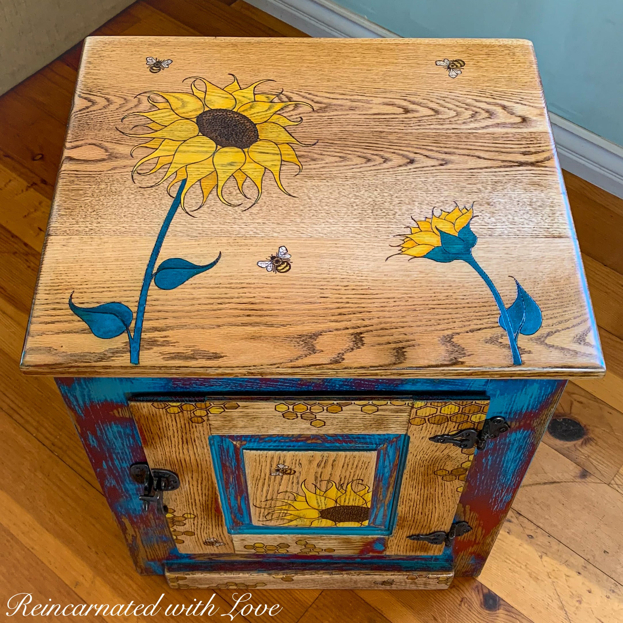 A boho vintage nightstand painted in distressed red & blue with honeycomb, sunflowers & bees.