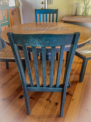 A closeup view of the blue patina finish on the back of a vintage chair seat with matching table.