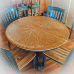 A closeup view of the stained wood tabletop on a country kitchen table with a shabby chic blue trim.