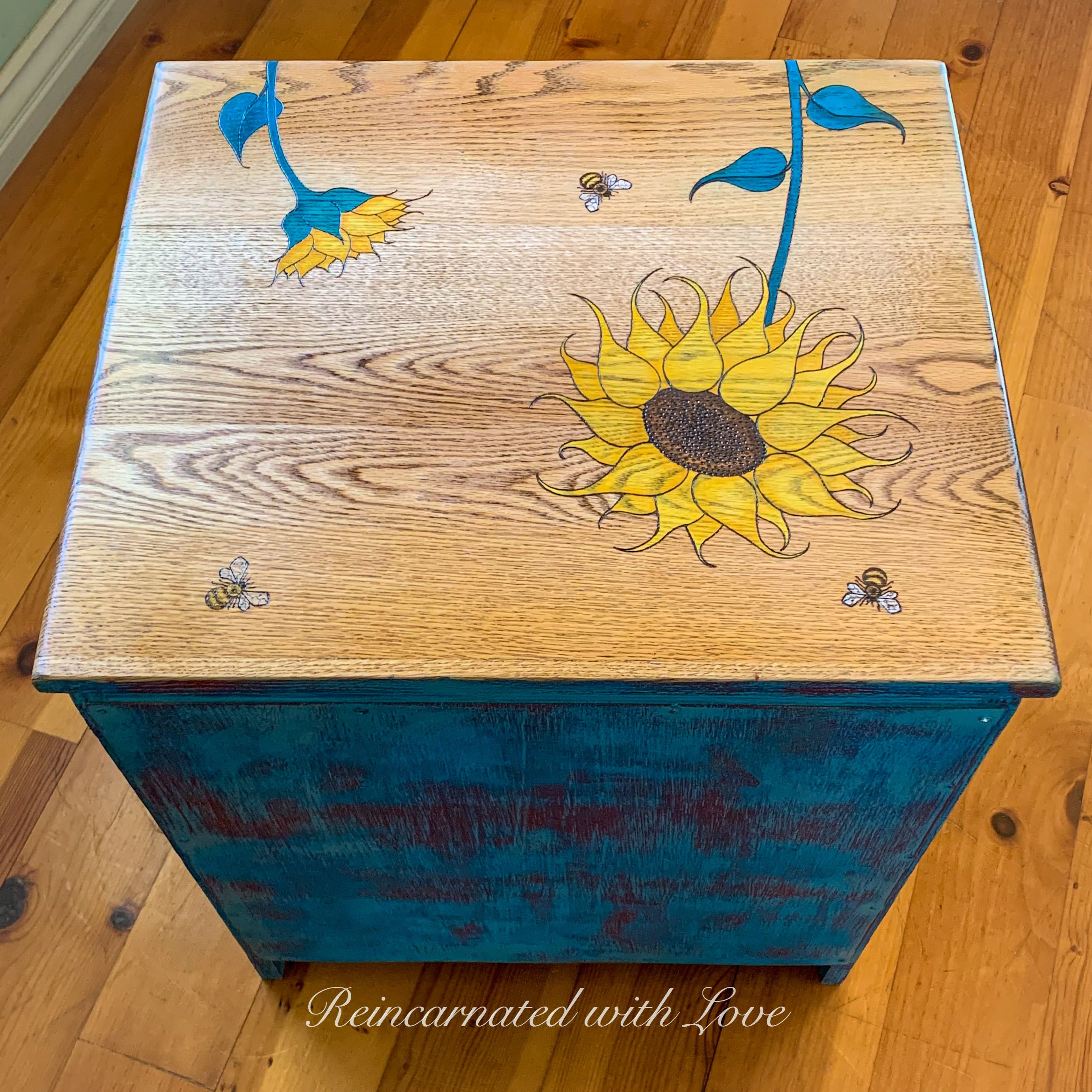 Top view of a painted vintage nightstand with burnt wood sunflower & bee accents.
