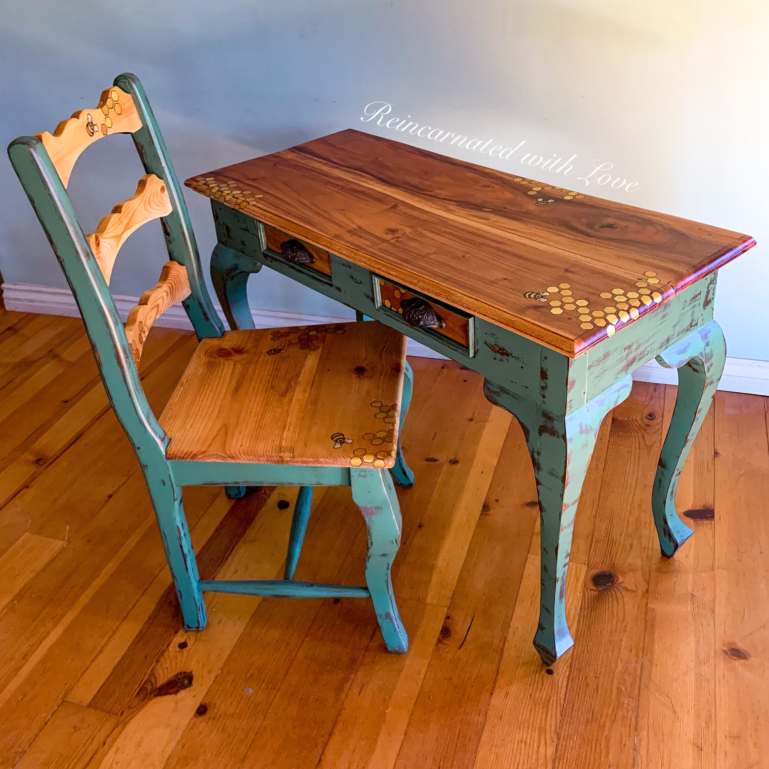 A french country desk & chair set done in stained wood & distressed green trim, with honeycomb & tiny bee accents.