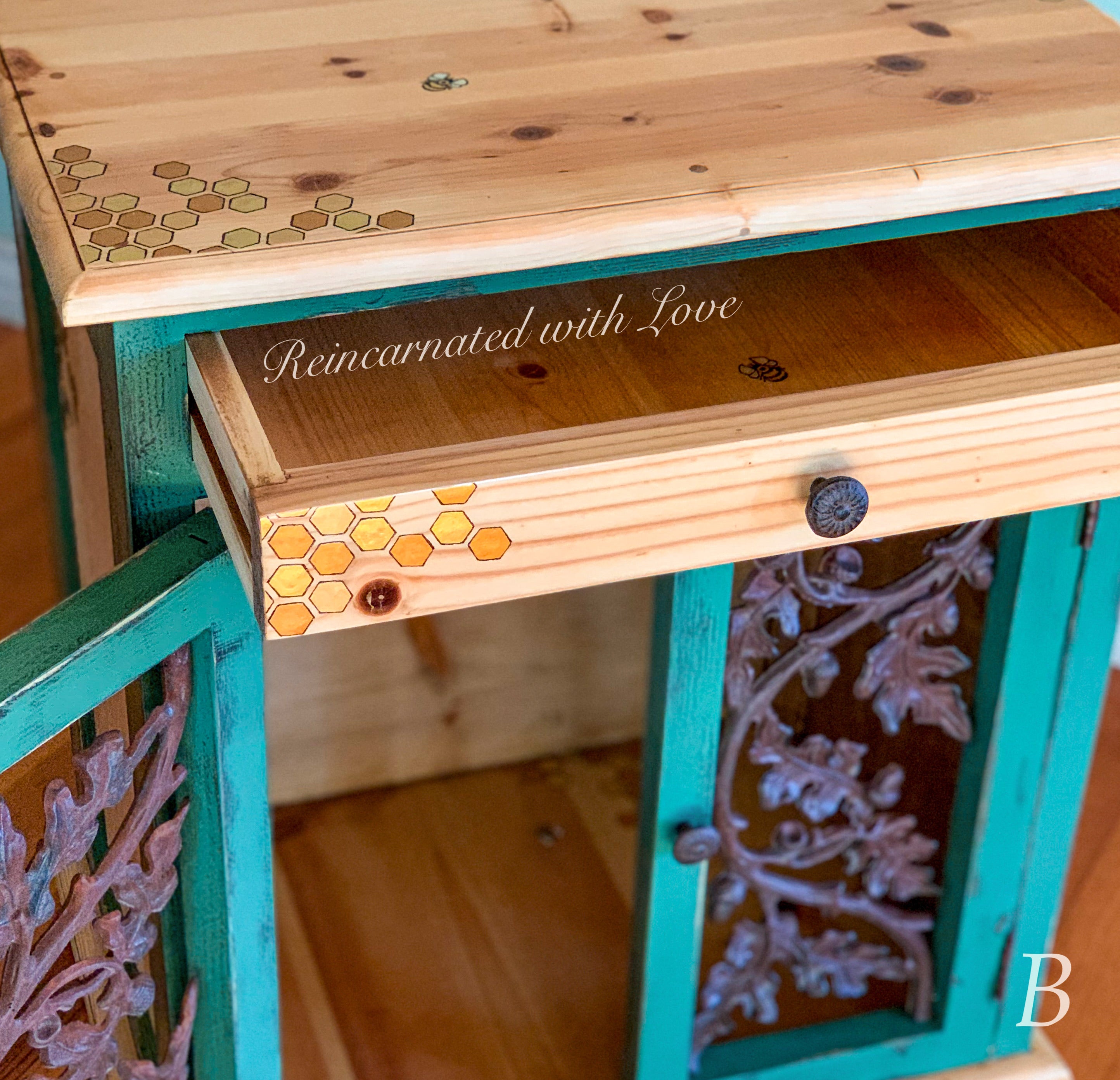 A wrought iron & stained wood nightstand in distressed green with honeycomb & tiny bee accents.